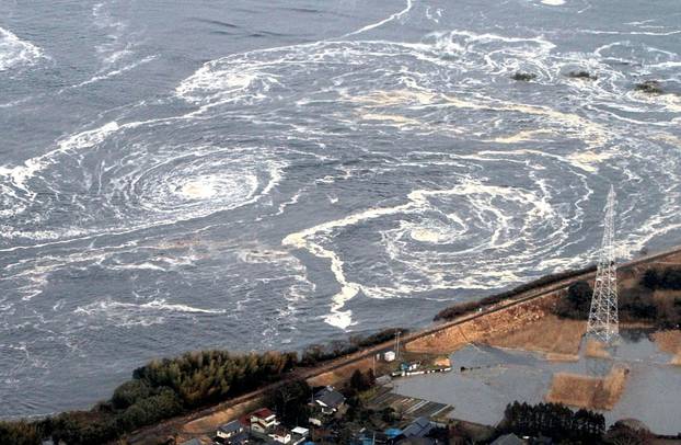 FILE PHOTO: Whirlpools are seen following a tsunami and earthquake in Iwaki city, Fukushima Prefecture