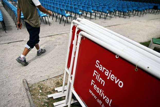 Organiser walks past seats at the open air cinema for the 12th Sarajevo Film Festival in Sarajevo