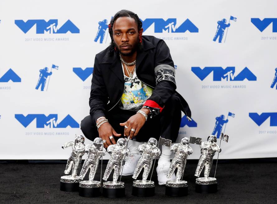 FILE PHOTO: Musician Kendrick Lamar poses for pictures with his awards at the 2017 MTV Video Music Awards in Inglewood
