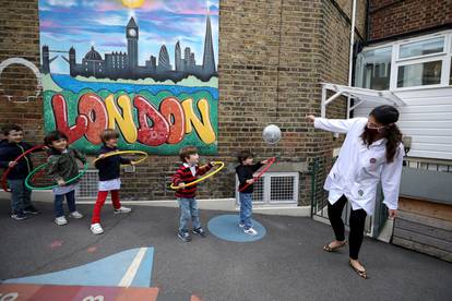 Children use hoops for social distancing at L'Ecole Des Petits school