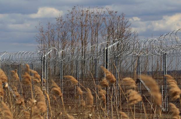 The Wider Image: In Hungary, one fence comes down, another goes up