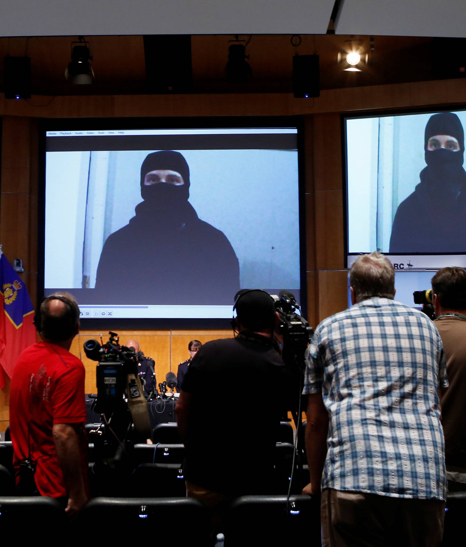 A video of Aaron Driver is projected on a screen during a news conference in Ottawa