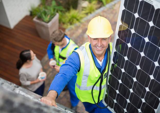 Worker,Installing,Solar,Panel,On,Roof