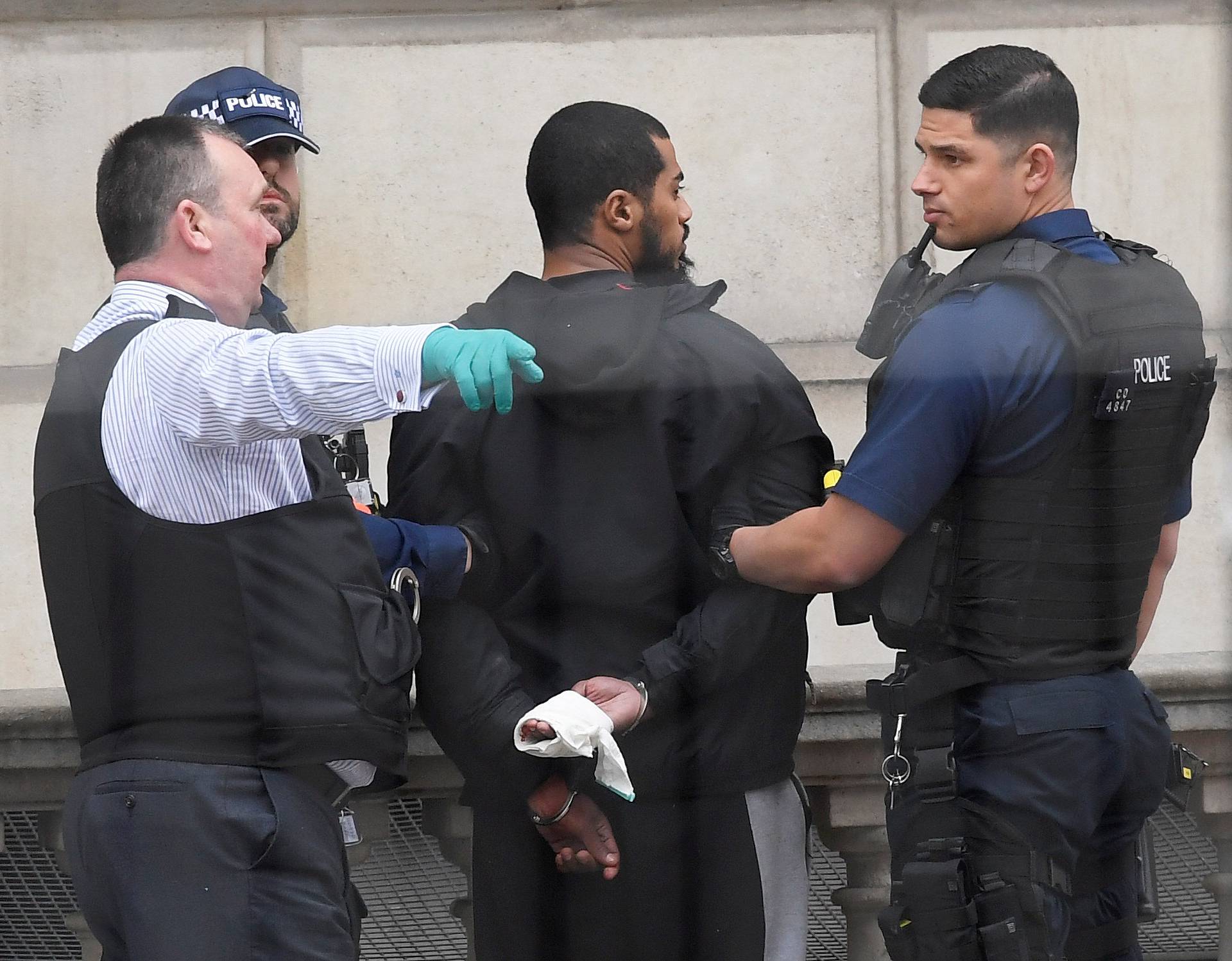 A man is held by police in Westminster after an arrest was made on Whitehall in central London
