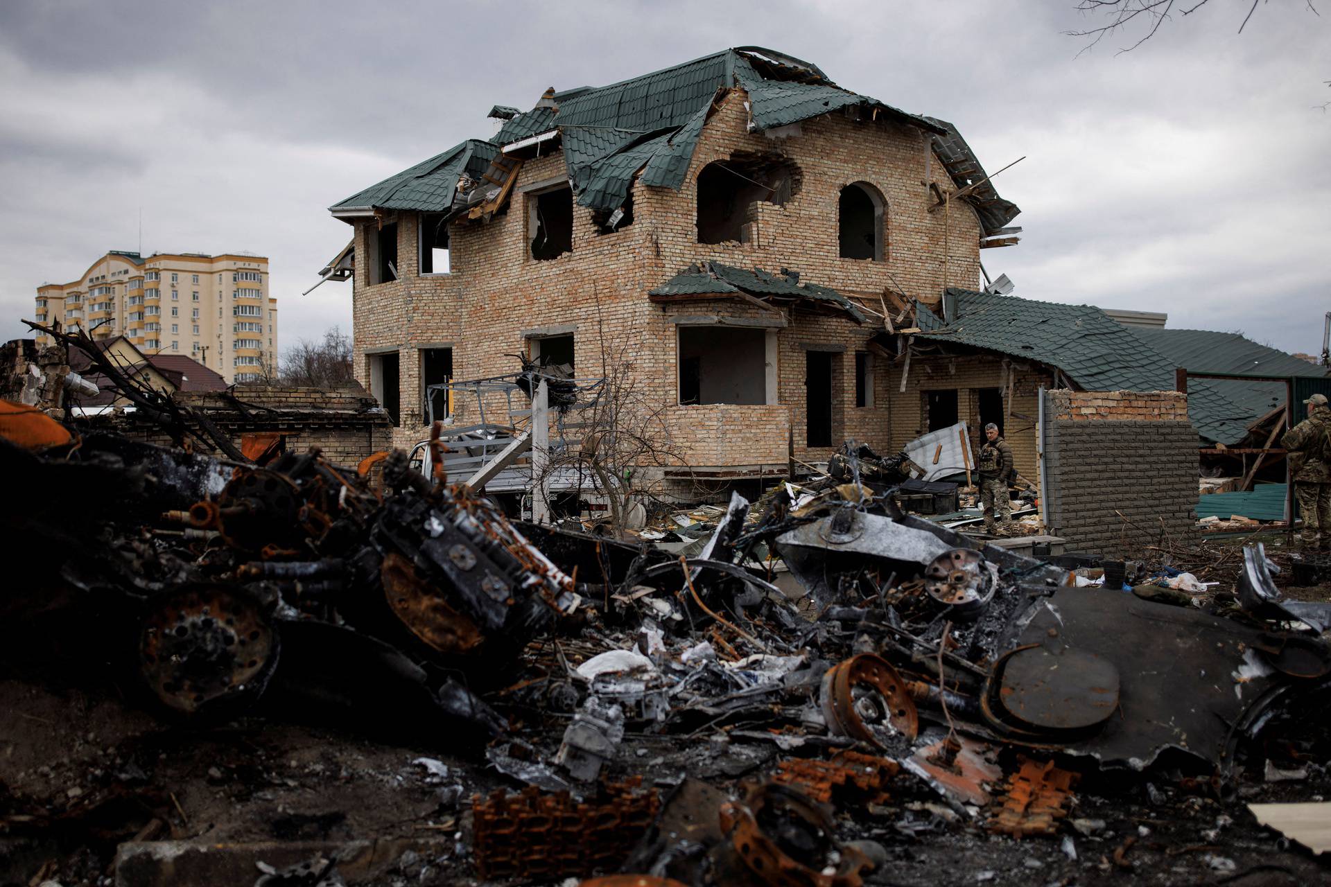 FILE PHOTO: Ukrainian soldiers inspect a destroyed house, amid Russia's invasion of Ukraine, in Bucha