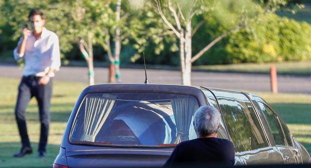 The car carrying the casket of soccer legend Diego Maradona arrives at the cemetery in Buenos Aires, Argentina