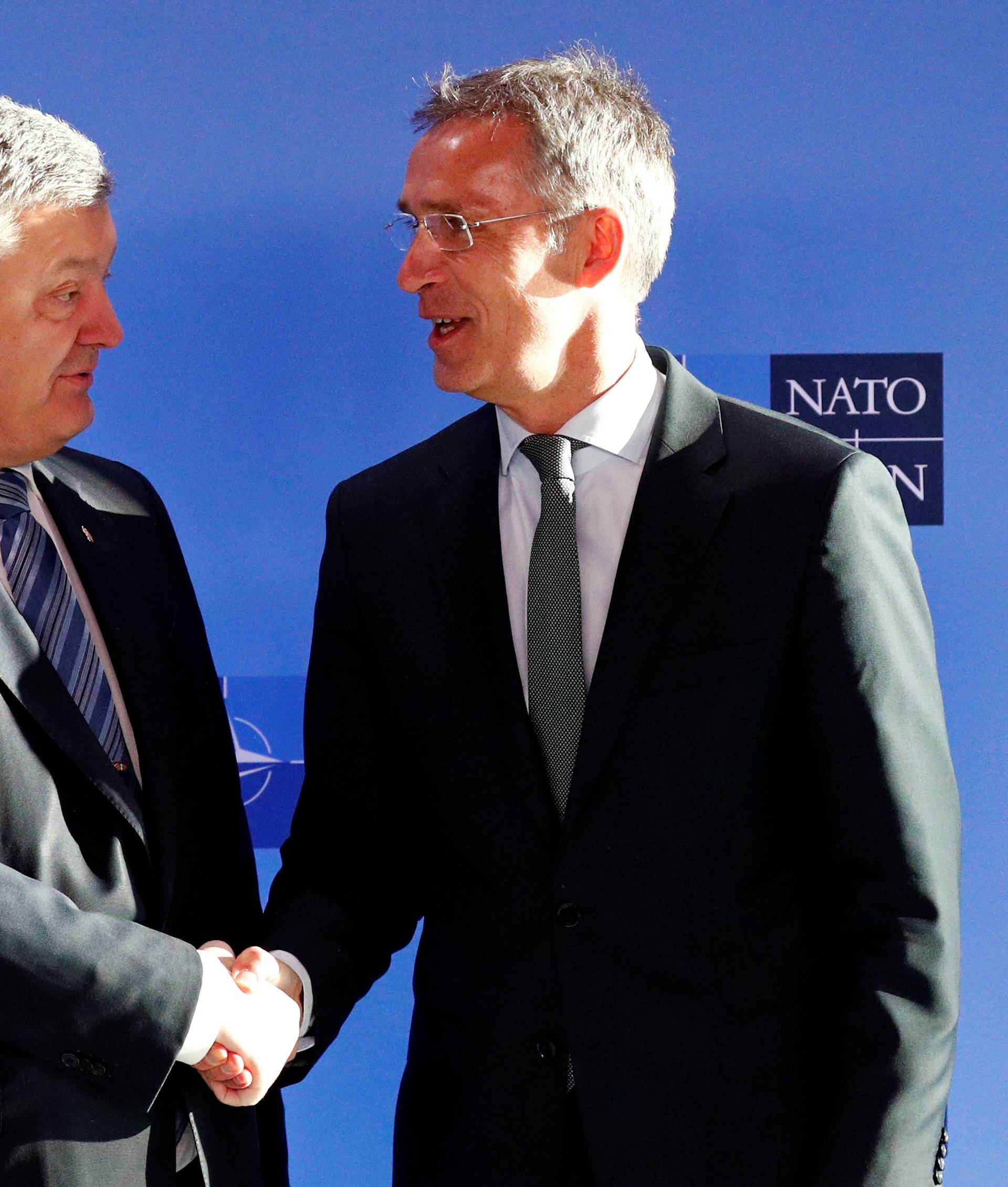 Ukrainian President Poroshenko poses with NATO's Secretary General Stoltenberg in Brussels