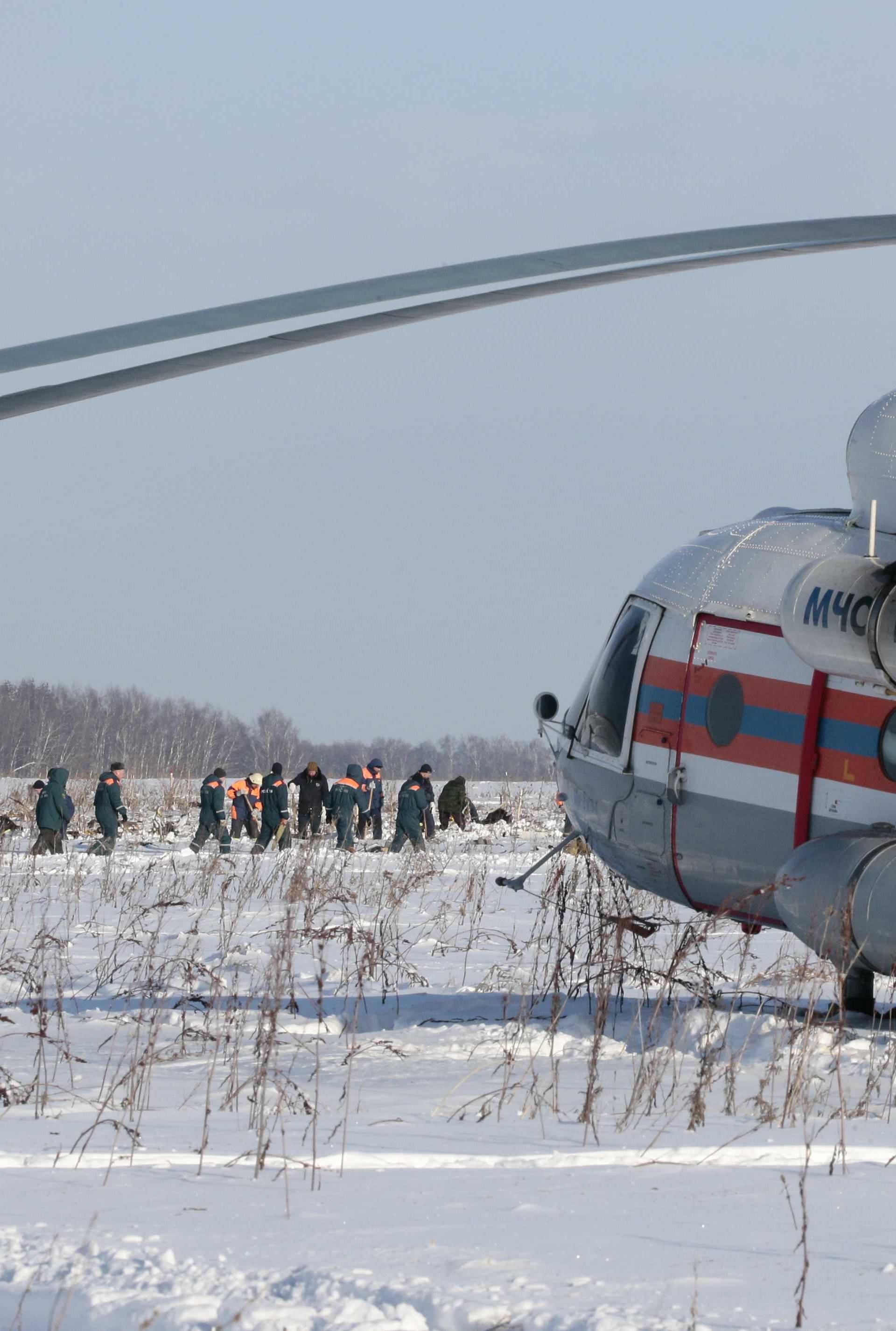 Russian Emergency Situations Ministry members work at the crash site of the short-haul AN-148 airplane operated by Saratov Airlines in Moscow Region