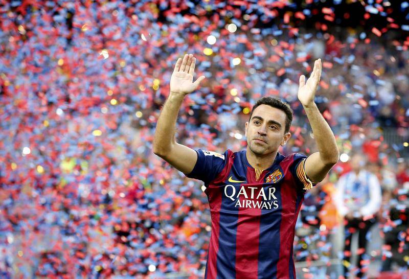 FILE PHOTO: Xavi Hernandez waves to Barcelona supporters after their Spanish first division soccer match against Deportivo de la Coruna at Camp Nou stadium in Barcelona