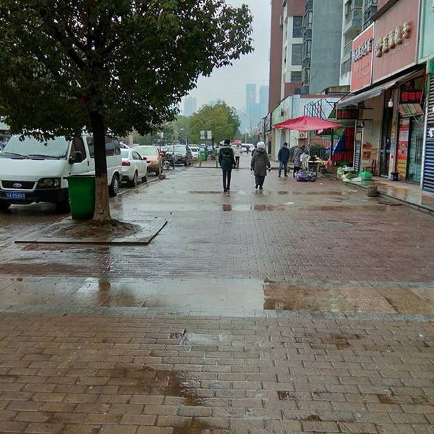 People walk along a street in Wuhan