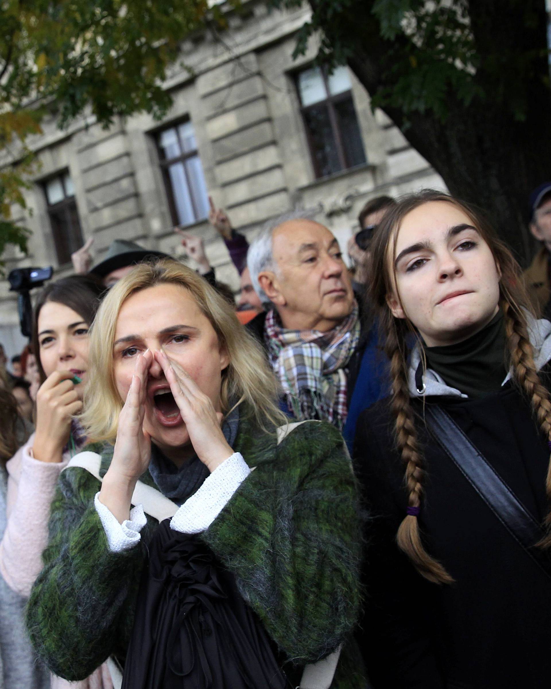 Protesters shout slogans during an anti-government demonstration taking place close to a ceremony marking the 60th anniversary of 1956 anti-Communist uprising in Budapest