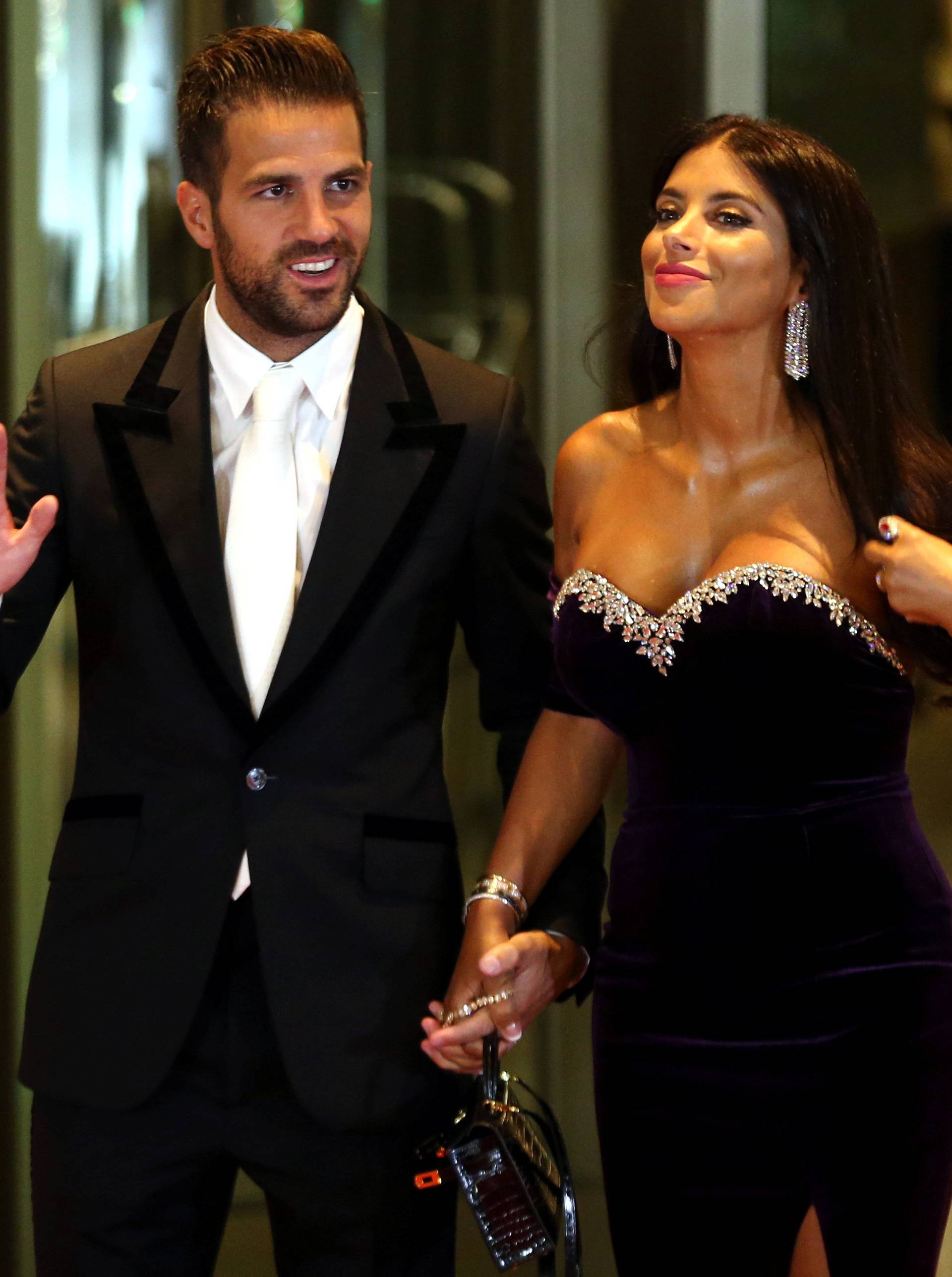 Argentine soccer player Lionel Messi's former Barcelona FC teammate Cesc Fabregas and his wife Daniella Semaan pose for photographers as they arrive to the wedding of Messi and Antonela Roccuzzo in Rosario