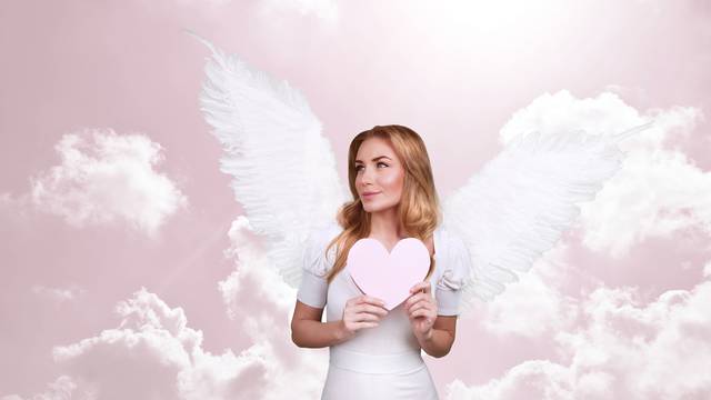 Angel of love, beautiful girl with great white feather wings in 