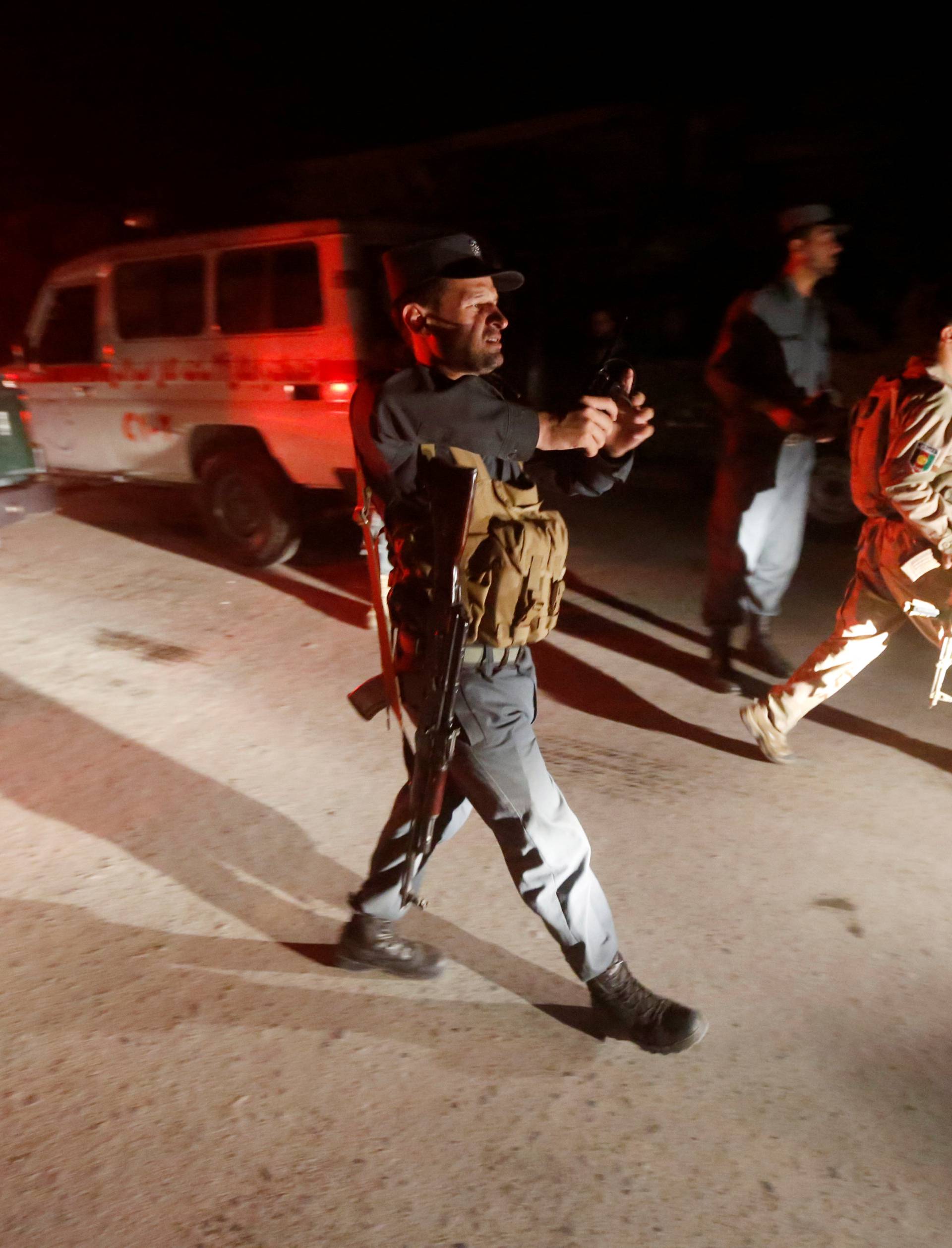 Afghan policemen stand guard at the site of an attack at American University of Afghanistan in Kabul