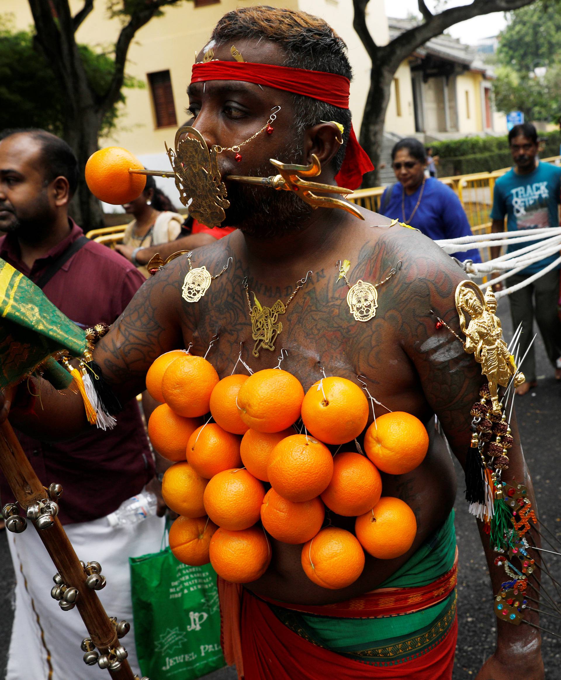 A devotee pulls a chariot during the Hindu festival of Thaipusam in Singapore