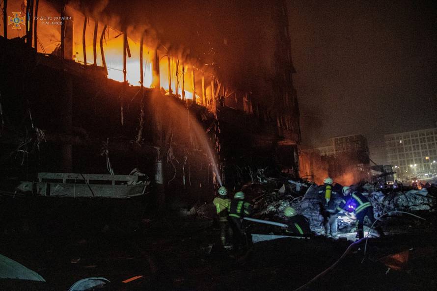 Rescuers work at a site of a shopping mall damaged by an airstrike in Kyiv