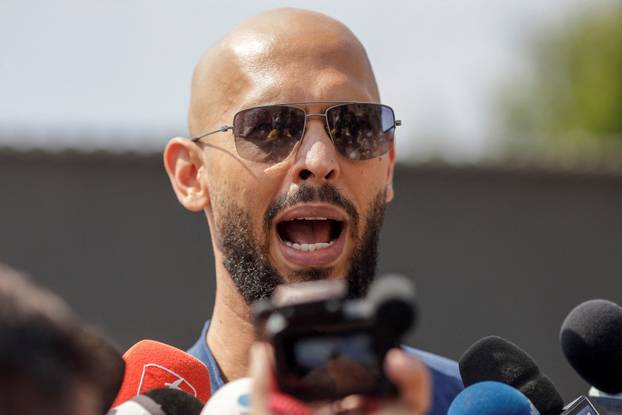 FILE PHOTO: Andrew Tate delivers a press statement outside his house