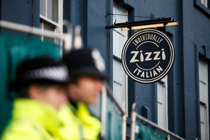 Police officers stand on duty outside a restaurant which has been secured as part of the investigation into the poisoning of former Russian inteligence agent Sergei Skripal and his daughter Yulia, in Salisbury