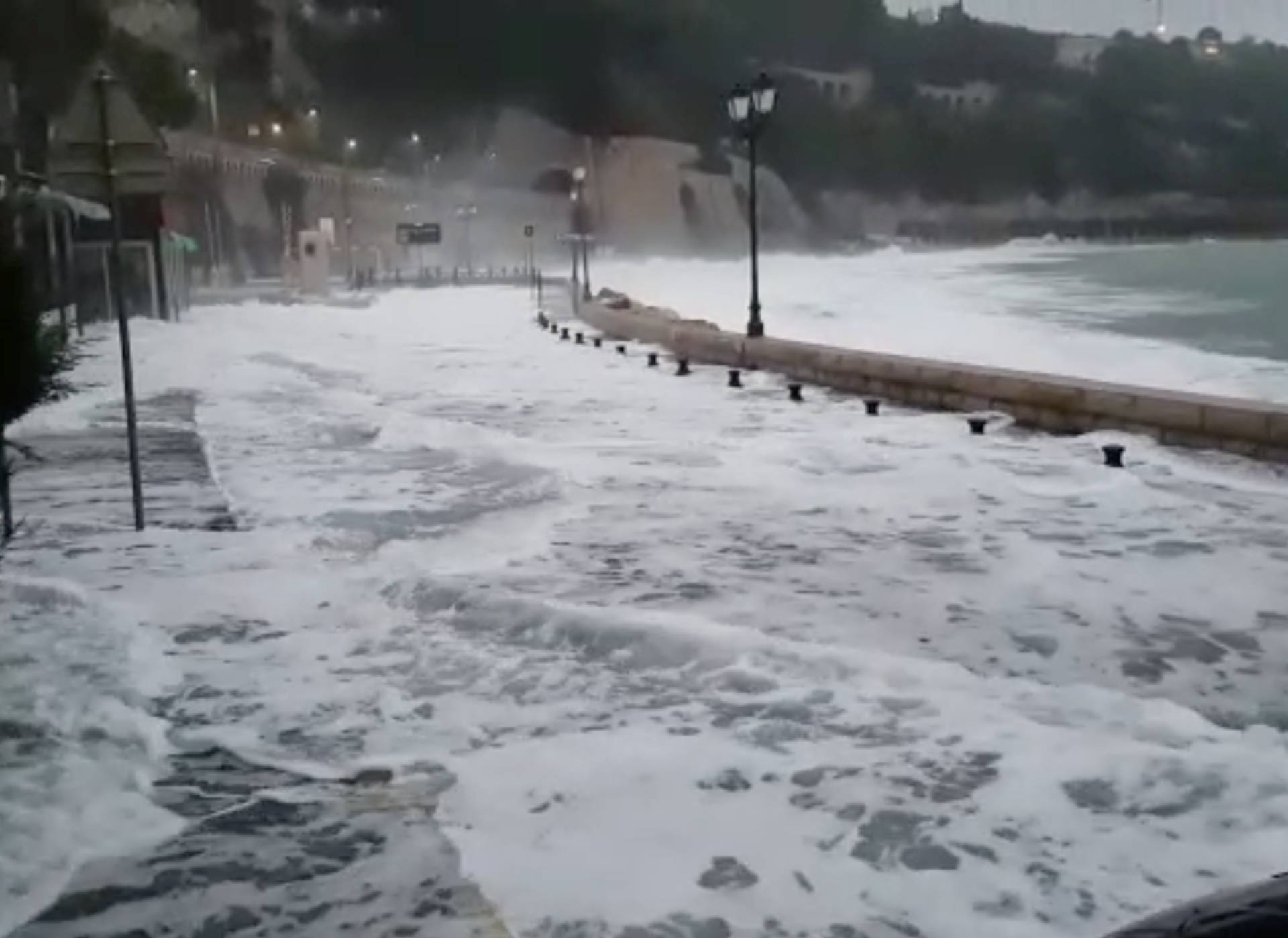 Waves flood the street in Villefranche-Sur-Mer