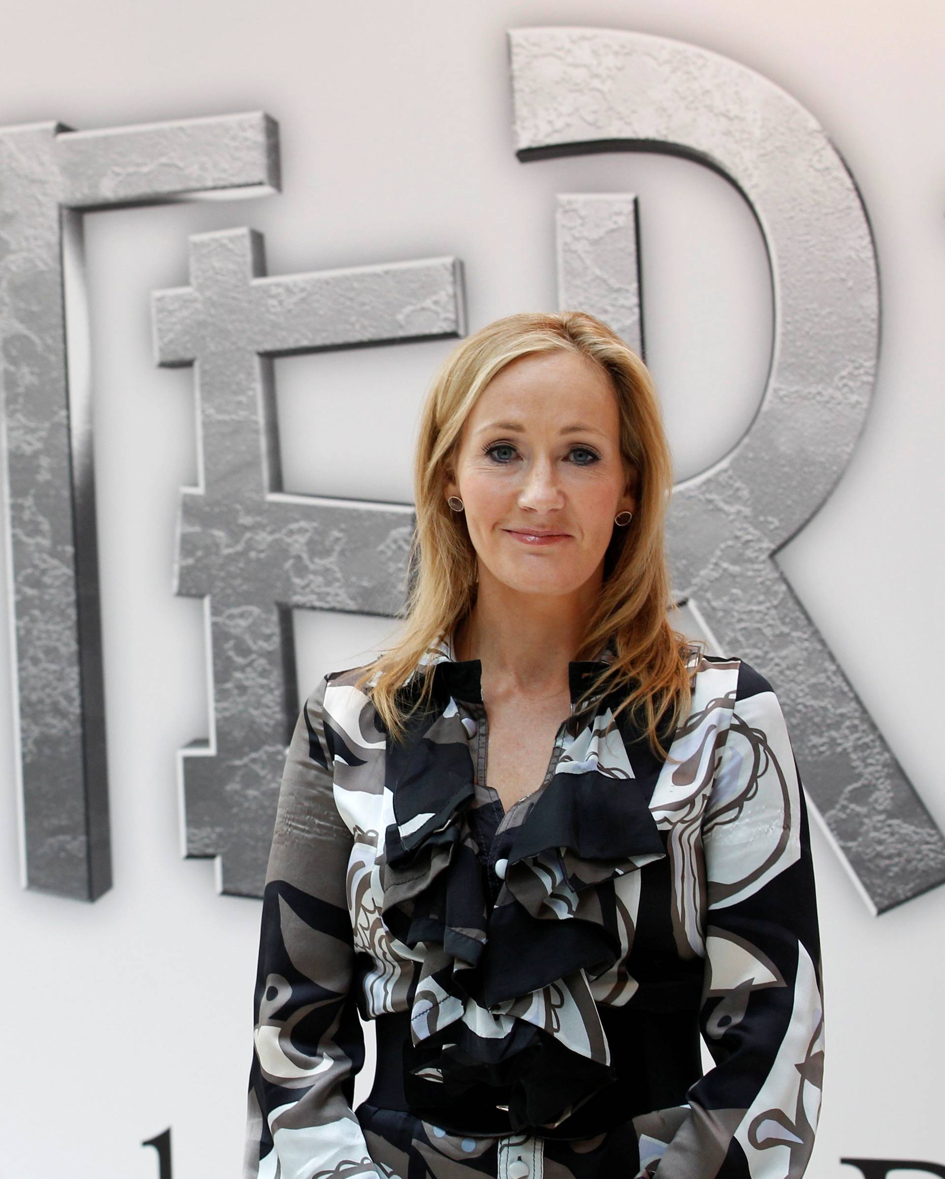 FILE PHOTO: British author JK Rowling, creator of the Harry Potter series of books, poses during the launch of new online website Pottermore in London