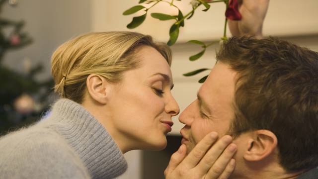 Couple kissing under the mistletoe