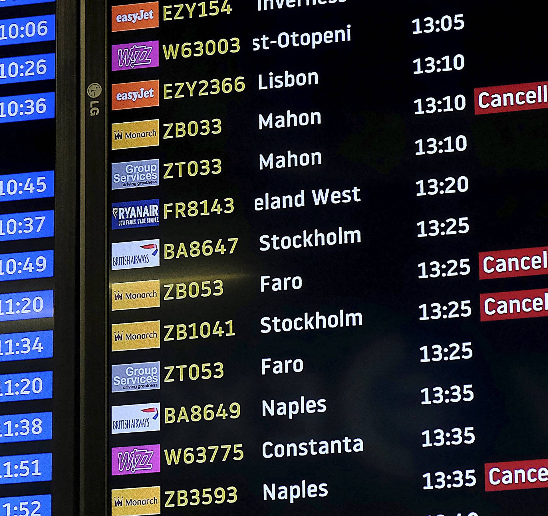 Screens display cancelled Monarch flights after the airline ceased trading, at Luton airport, Britain