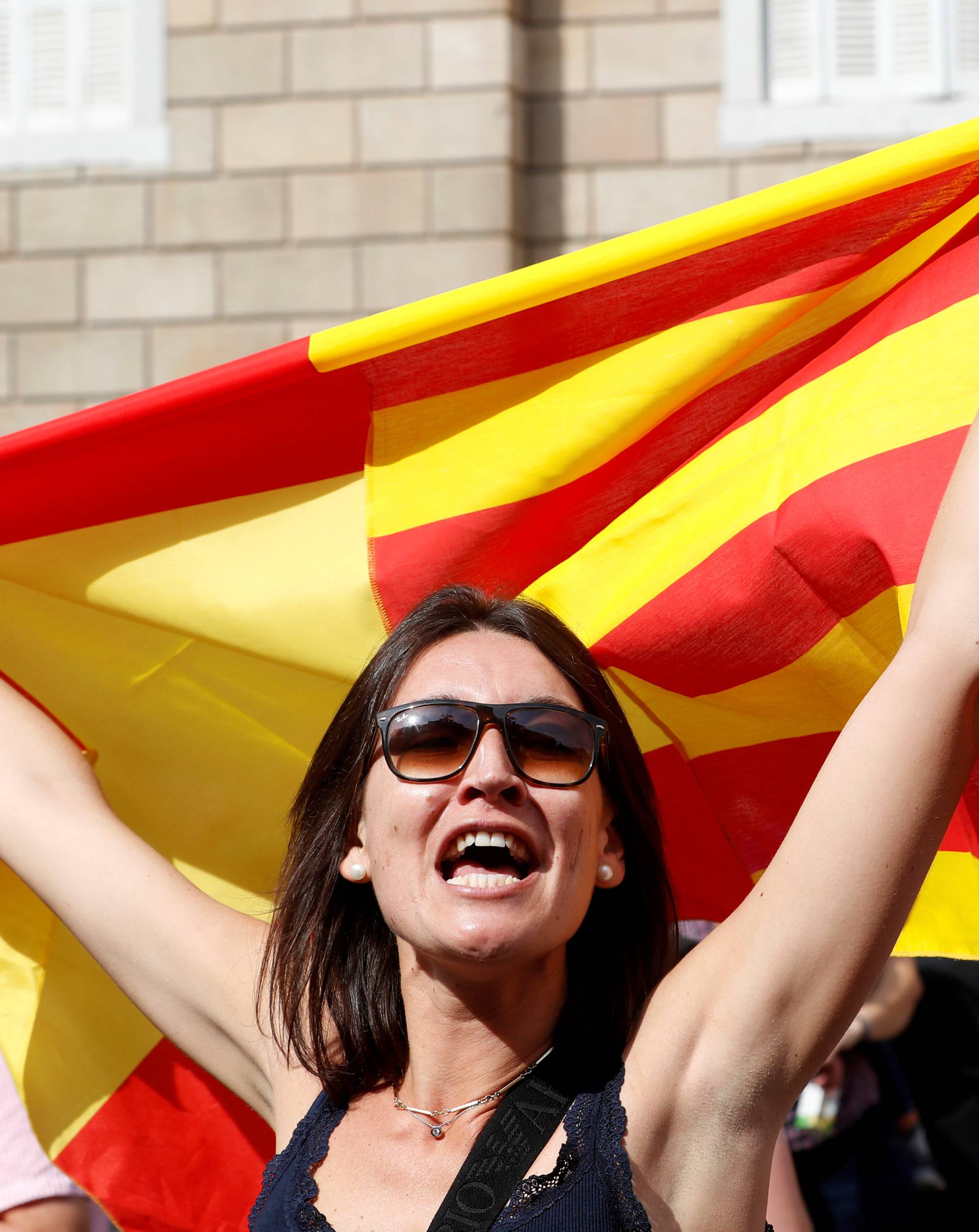 A woman holds up a Spanish flag during a demonstration in favor of a unified Spain a day before the banned October 1 independence referendum in Barcelona