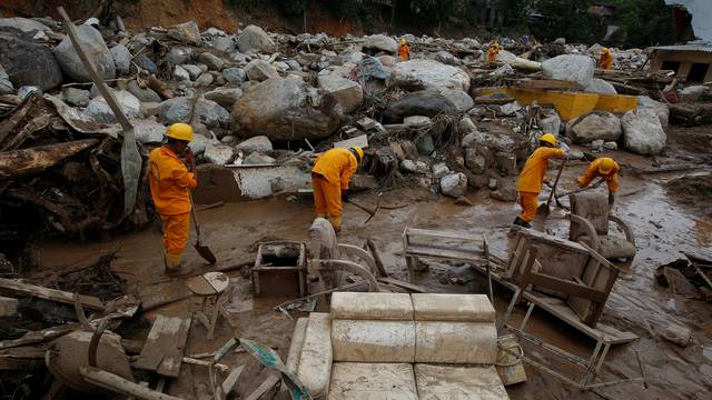 Rescuers look for bodies in a destroyed area, after flooding and mudslides caused by heavy rains leading several rivers to overflow, pushing sediment and rocks into buildings and roads, in Mocoa