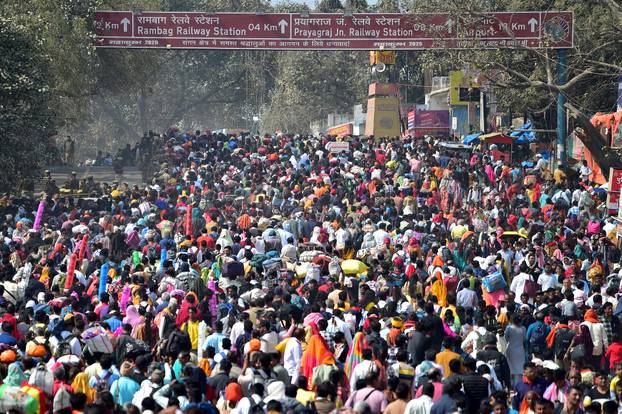 Devotees head towards busses and railway stations as they leave Sangam during the "Maha Kumbh Mela" in Prayagraj