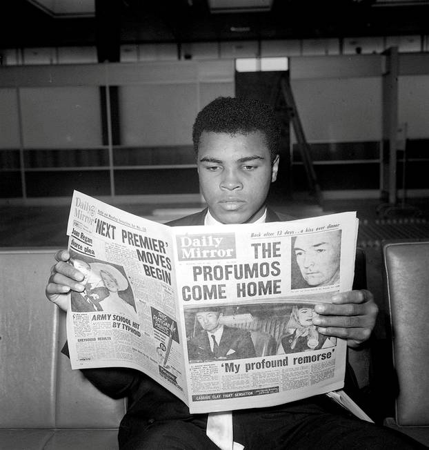 Cassius Clay (later Muhammad Ali)  reads the newspapers in London