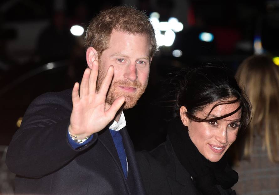 Britain's Prince Harry and his fiancee Meghan Markle leave Star Hub, a community and leisure centre, in Cardiff