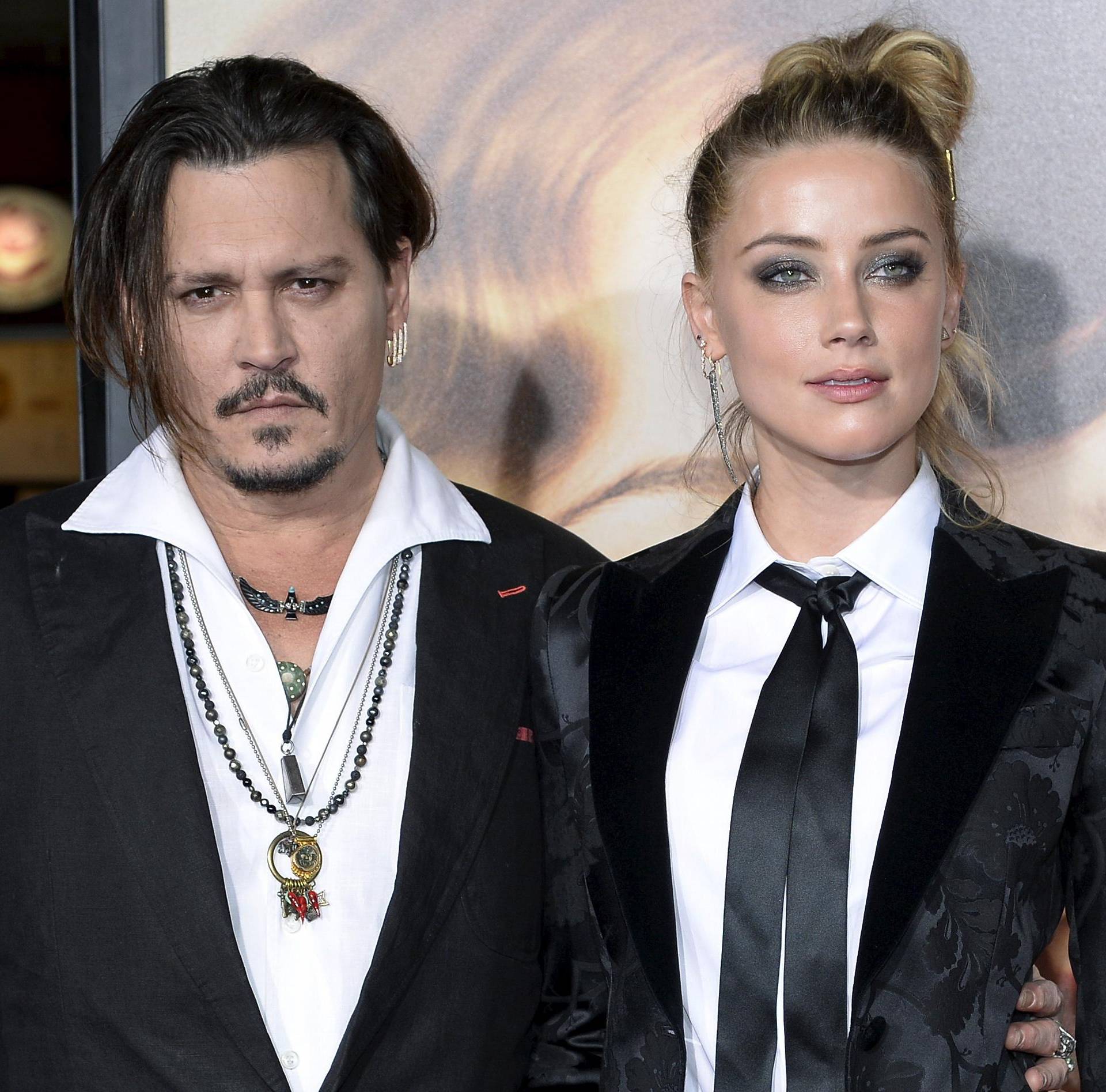 Cast member Amber Heard and husband Johnny Depp pose during the premiere of the film "The Danish Girl," in Los Angeles