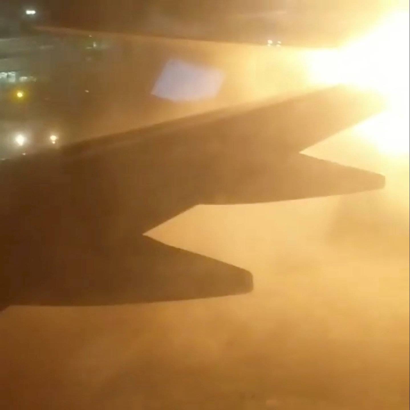 An explosion is seen through a window of a plane that has collided with another plane at Toronto's Pearson Airport, Canada