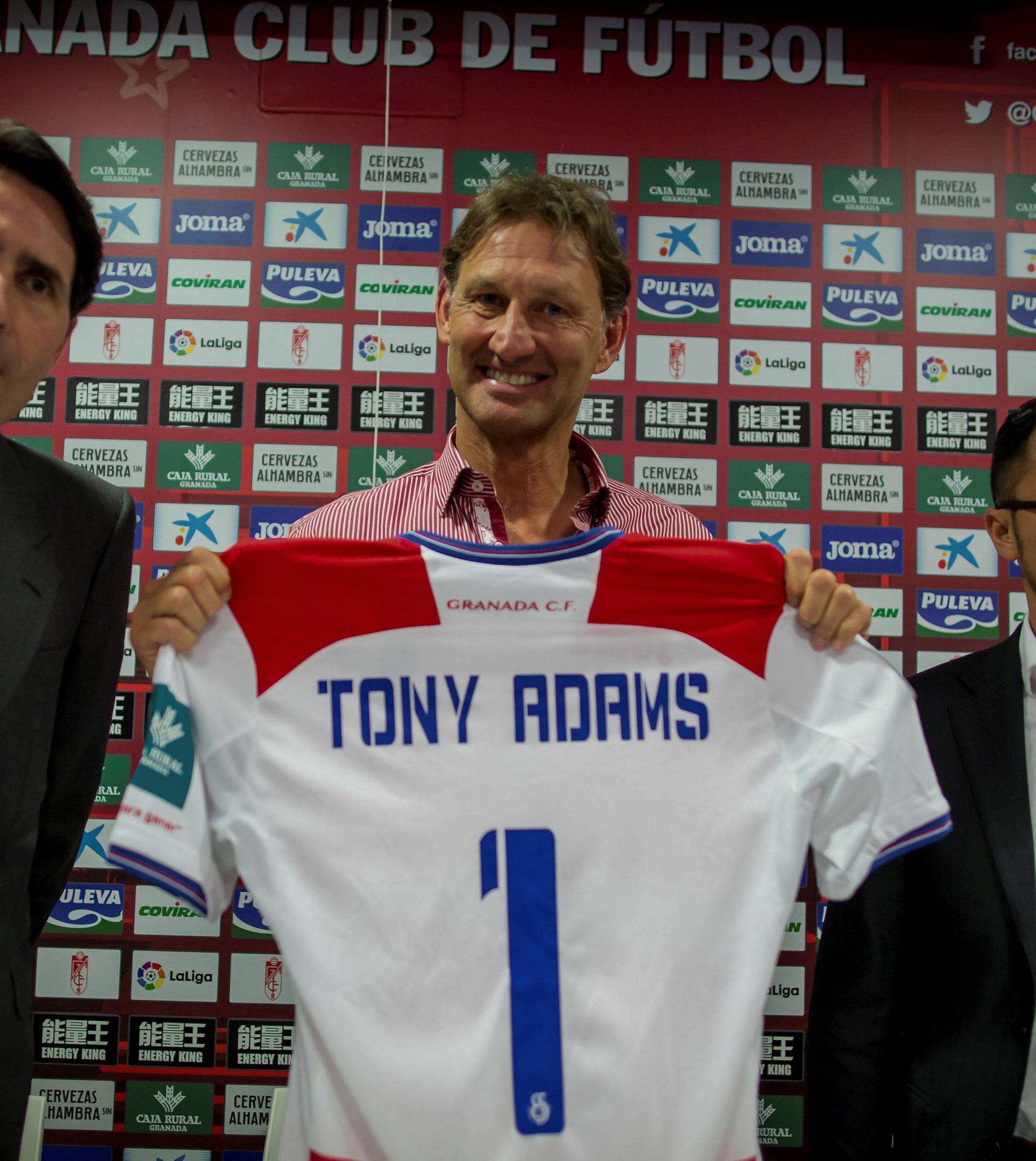 Former Arsenal and England captain Adams holds a Granada's jersey as he is flanked by VP Wang and board member Cuerva after being presented as new head coach in Granada