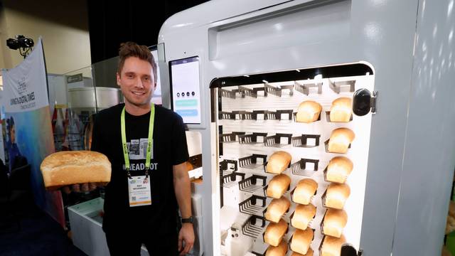 Eric Wilkinson stands by the Wilkinson Baking Company Breadbot, a self-contained, automated bakery, at "CES Unveiled" during the 2019 CES in Las Vegas