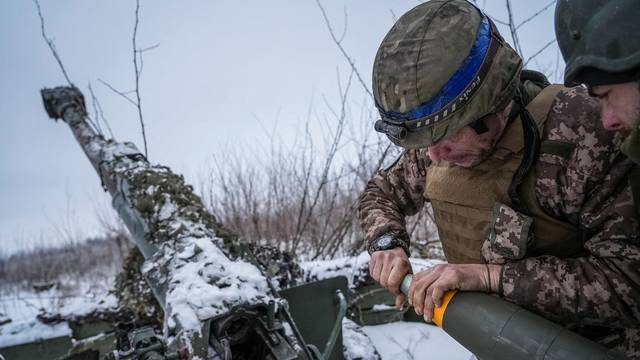 Ukrainian servicemen prepare fire a 120-mm towed artillery pieces-mortar towards Russian troops at a position near Bakhmut