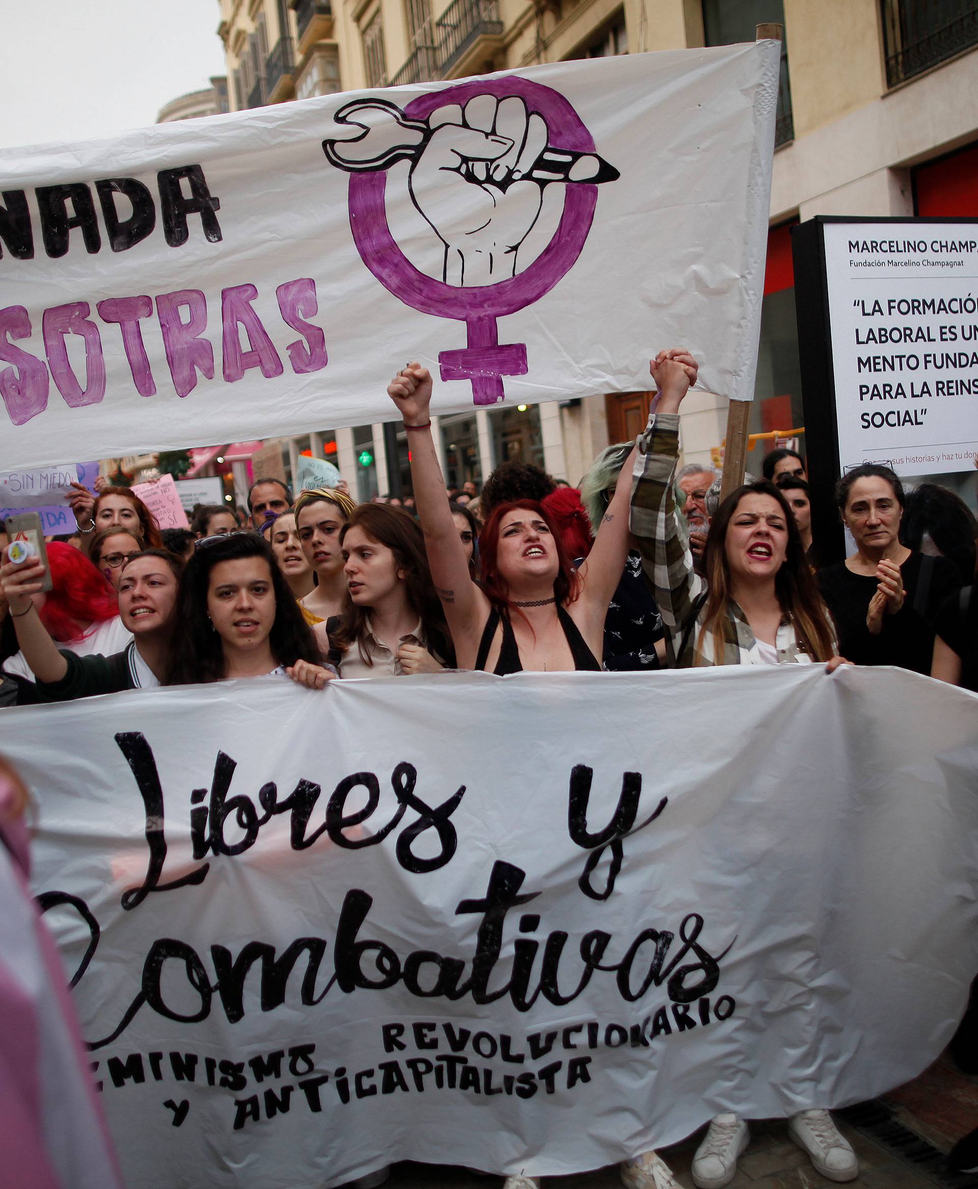 People shout slogans during a protest in Malaga