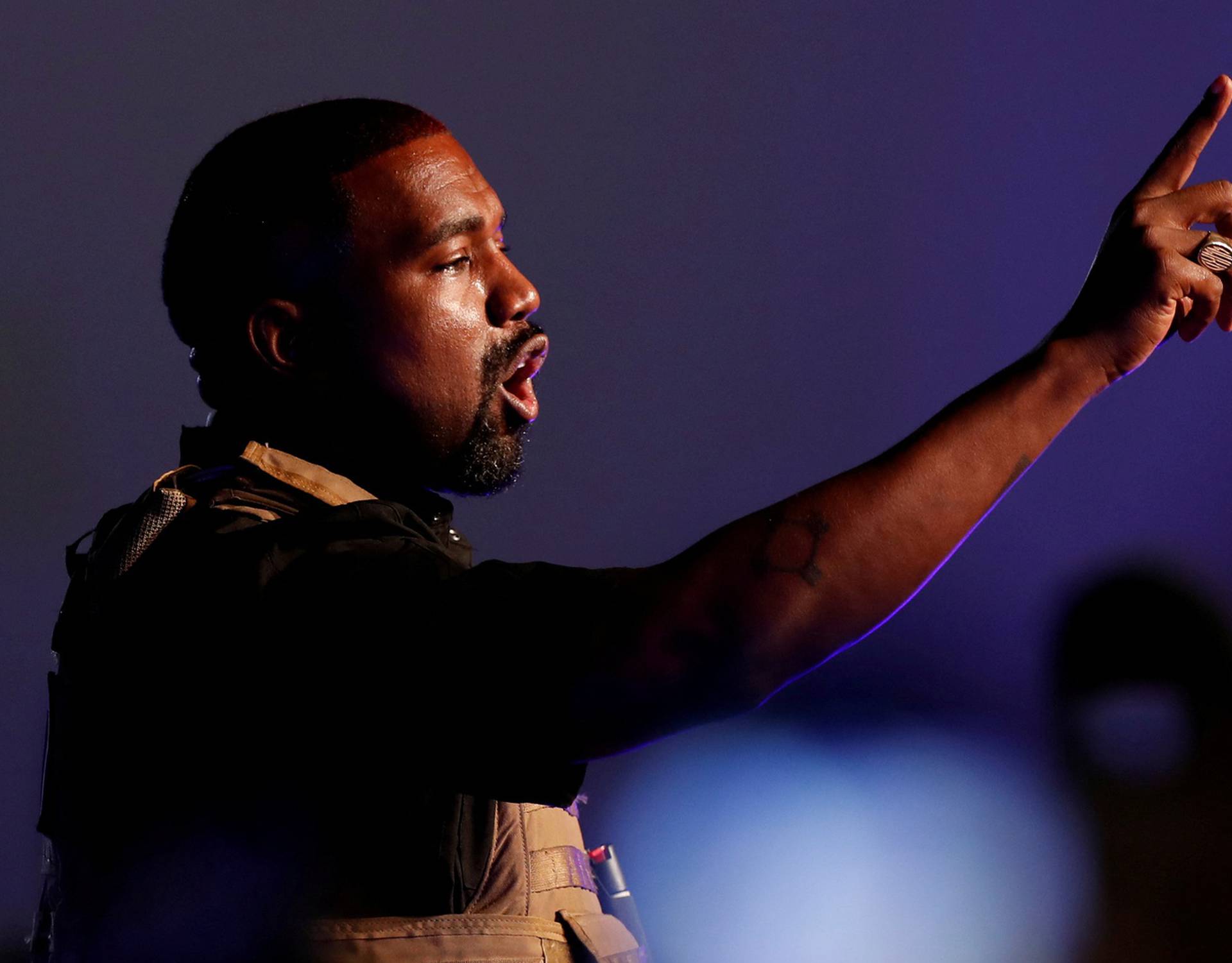 FILE PHOTO: Rapper Kanye West gestures to the crowd as he holds his first rally in support of his presidential bid in North Charleston