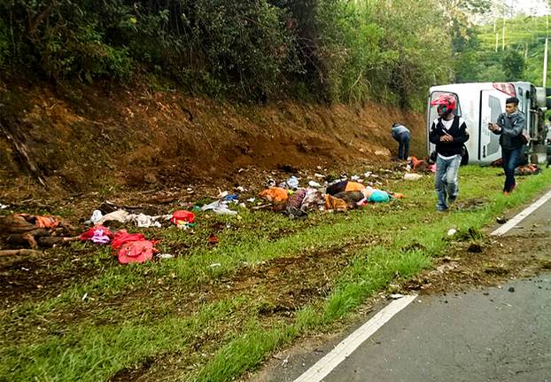People examine the site of fatal tourist bus accident in Subang Regency