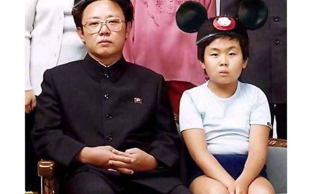 Kim Jong Il looks at the camera with Mickey....
