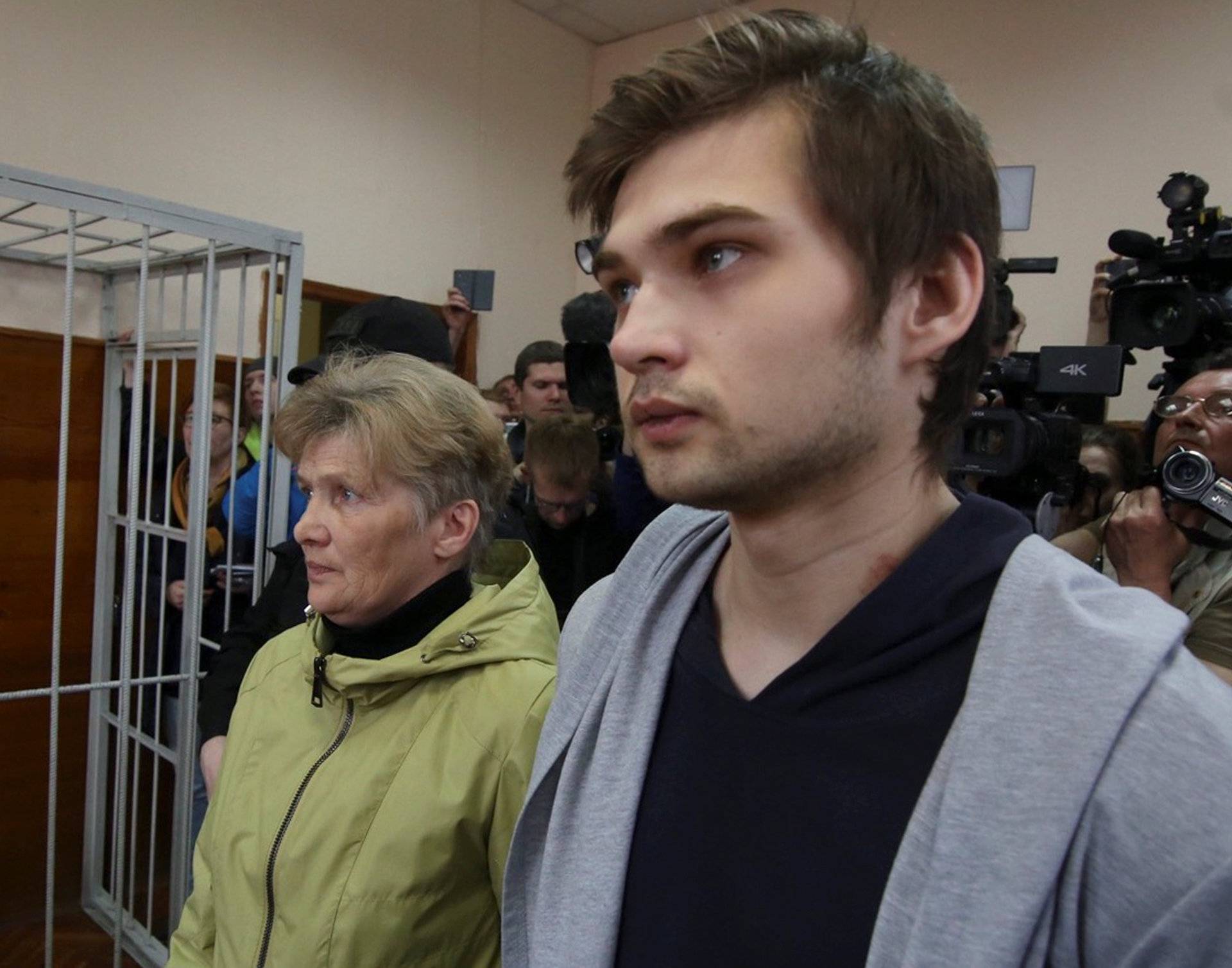 Ruslan Sokolovsky, a blogger who is accused by a state prosecutor for playing Pokemon Go inside an Orthodox church, appears with mother Yelena Chingina in a court during his sentencing in Yekaterinburg