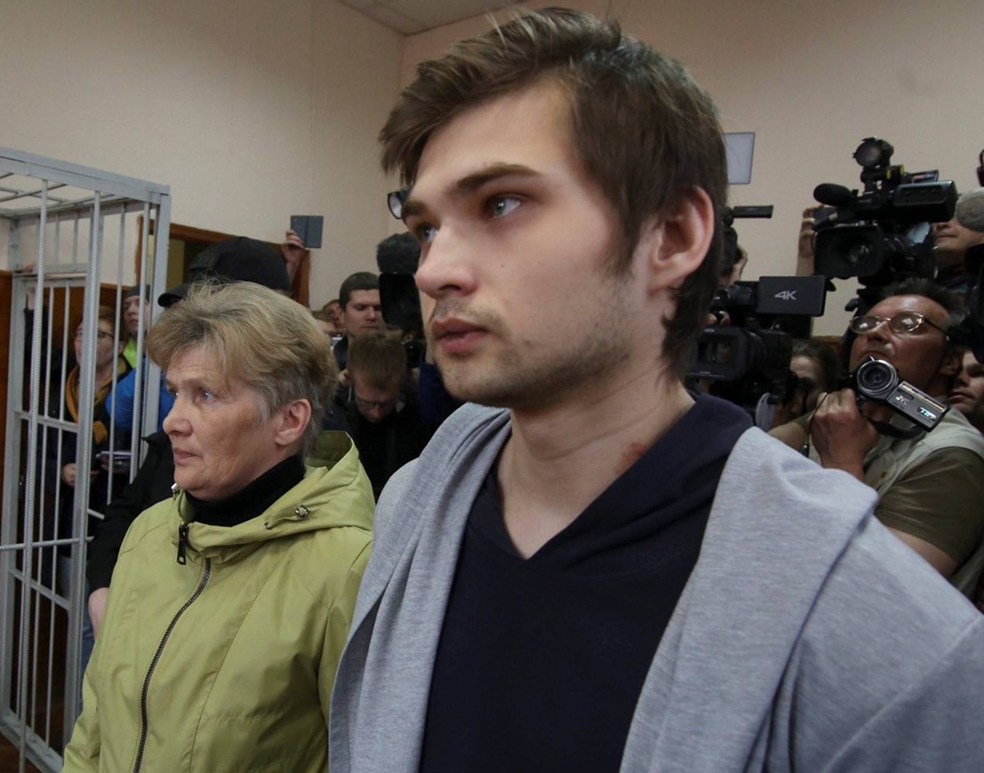 Ruslan Sokolovsky, a blogger who is accused by a state prosecutor for playing Pokemon Go inside an Orthodox church, appears with mother Yelena Chingina in a court during his sentencing in Yekaterinburg