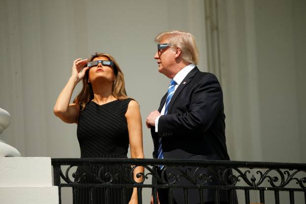 U.S. President Trump watches the solar eclipse with first Lady Melania Trump from the Truman Balcony at the White House in Washington