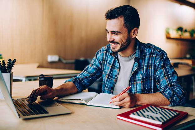 Cheerful,Young,Male,Student,Enjoying,Training,Webinar,On,Laptop,Computer