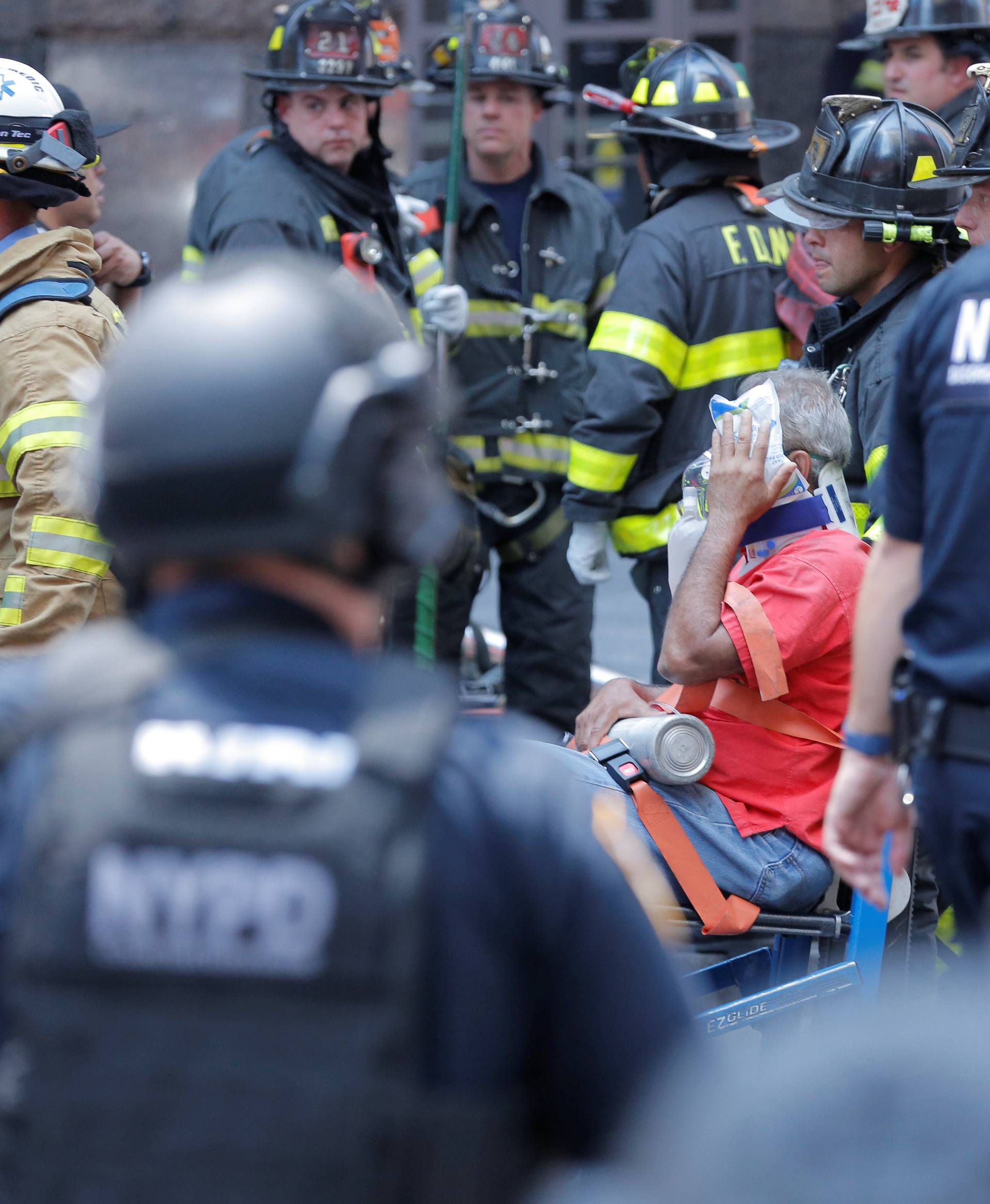 First responders tend to an injured pedestrian after a vehicle struck pedestrians on a sidewalk in Times Square in New York