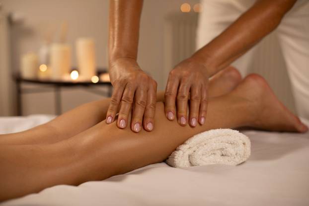Young,Woman,Having,Feet,And,Legs,Massage,In,Spa,Salon,