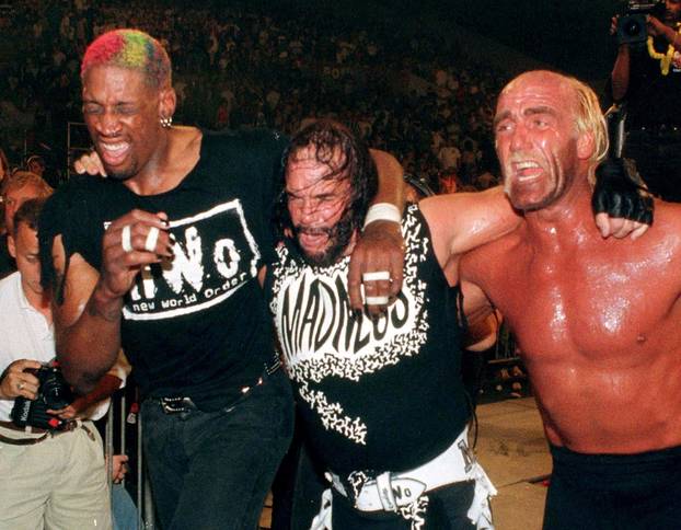 Chicago Bulls forward Dennis Rodman departs the ring with teammates Hulk Hogan and " Macho Man" Randy Savage after they lost their World Championship Wrestling match in Daytona Beach