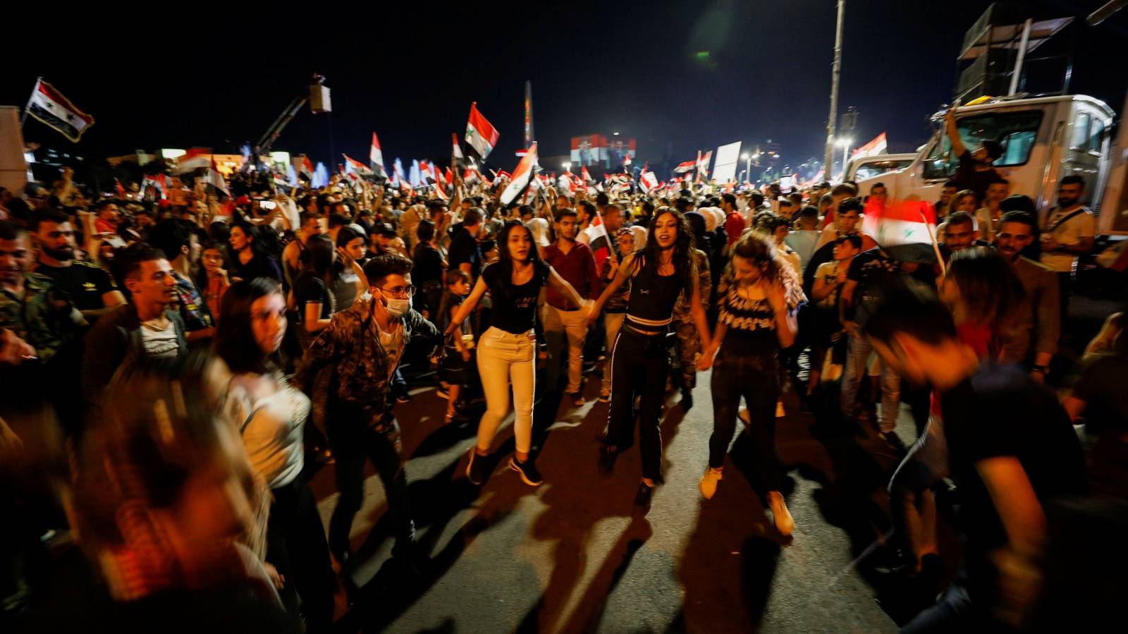 Supporters of Syria's President Bashar al-Assad celebrate before the results of the presidential election in Damascus