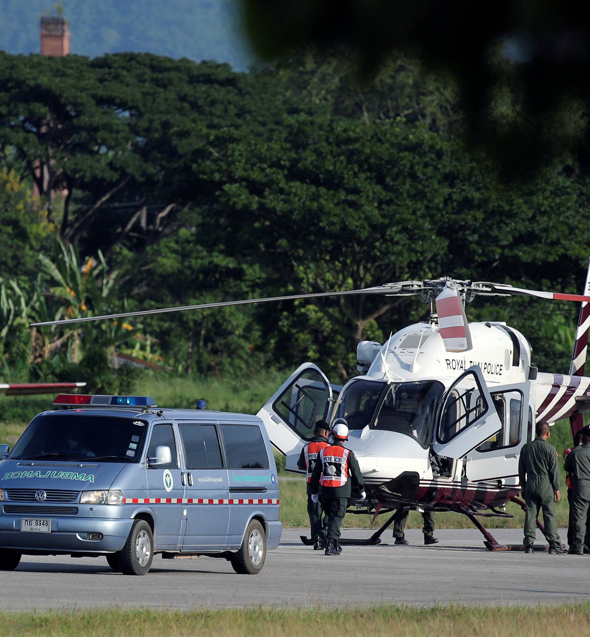 An ambulance carrying rescued schoolboys travels to a hospital from a military airport in Chiang Rai