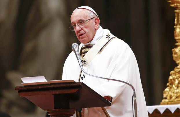 Pope Francis speaks as he leads the Christmas night Mass in Saint Peter